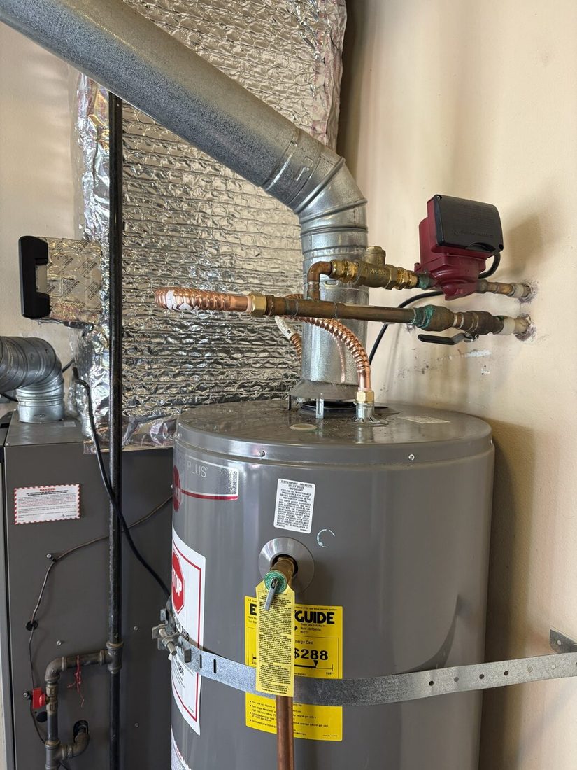 Close-up of water heater connections and venting