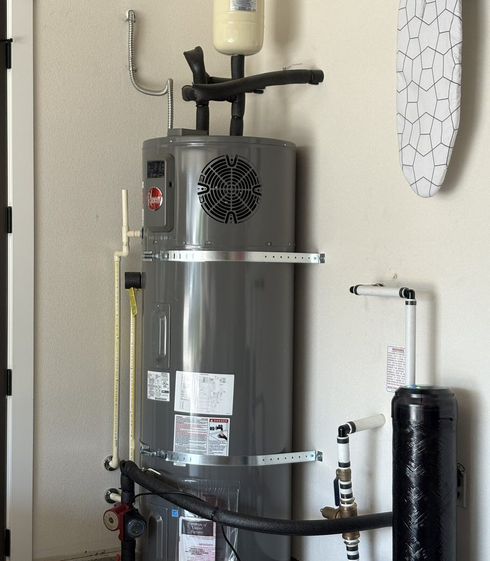 Hybrid heat pump water heater installed near filtration equipment